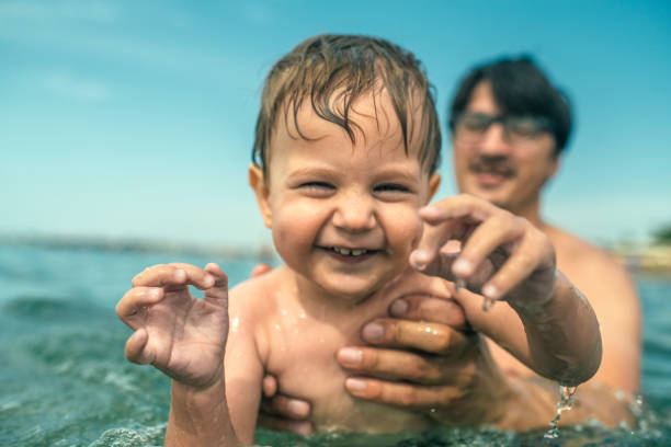 Child having fun in the sea on summer holidays