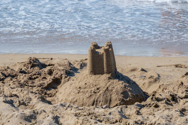 istock Sand towers, pillar figure on sandy beach and seaside 1155486295