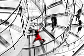 Blurred Motion of People Running down Futuristic Modern Spiral Staircase