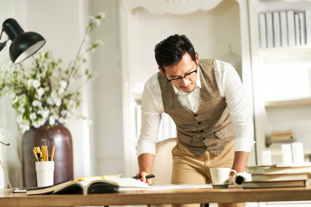 istock asian architet working in home office 1155487877