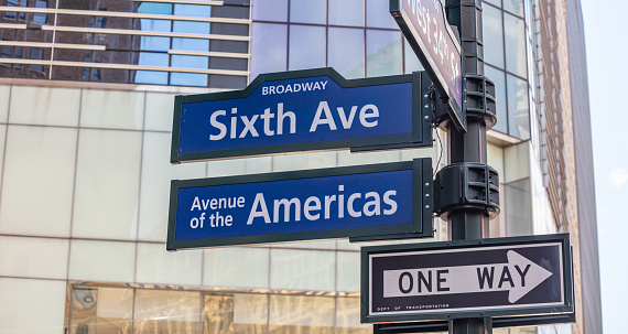 Sixfth ave Broadway street sign, Manhattan New York downtown. Blue signs on blur buildings facade background, Avenue of the Americas