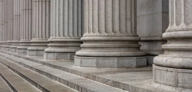 Photo of Stone pillars row and stairs detail. Classical building facade