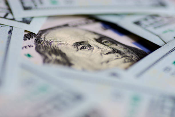 istock Benjamin Franklin's look on a hundred dollar bill. Benjamin Franklin portrait macro 1155489431