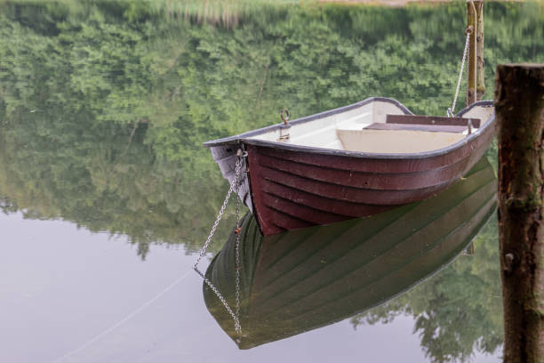istock a chained rowing boat floats on a lake 1155489457