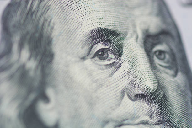 istock Benjamin Franklin's look on a hundred dollar bill. Benjamin Franklin portrait macro 1155489470