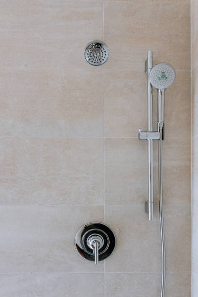 istock New shower head in the bathroom, close-up wall 1155489504