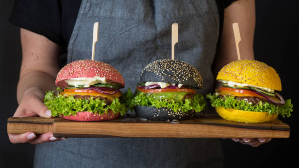 istock Women Holding Burgers 1155490602