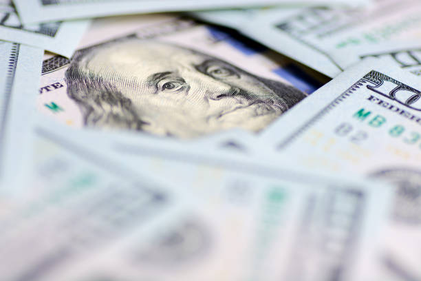 istock Benjamin Franklin's look on a hundred dollar bill. Benjamin Franklin portrait macro 1155490684