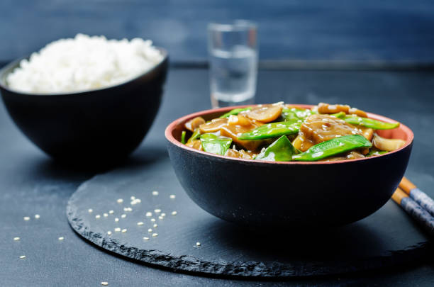 istock Snap peas Mushrooms Stir Fry with rice 1155492472