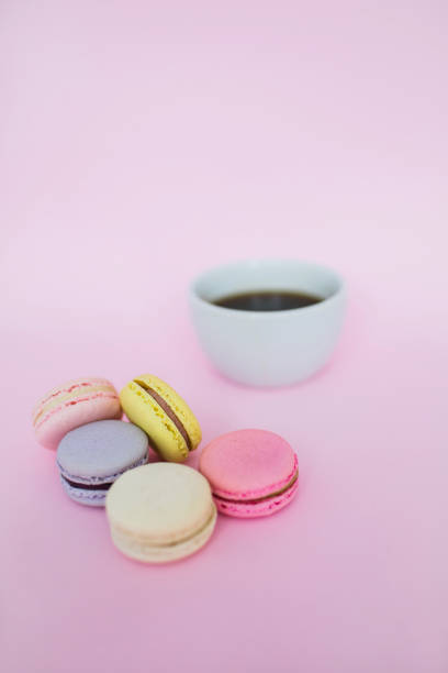 istock Macaroons and a cup of coffee on a pink background. 1155494584