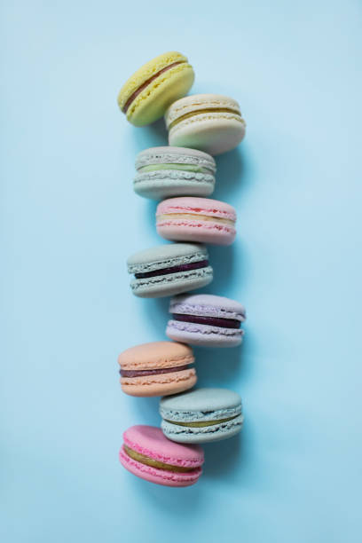 istock Cake macaron or macaroon on pastel blue background from above. Top view. 1155494595