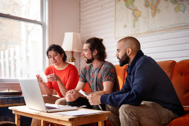 istock Millenial multi-ethnic friends calculating bills 1155497152
