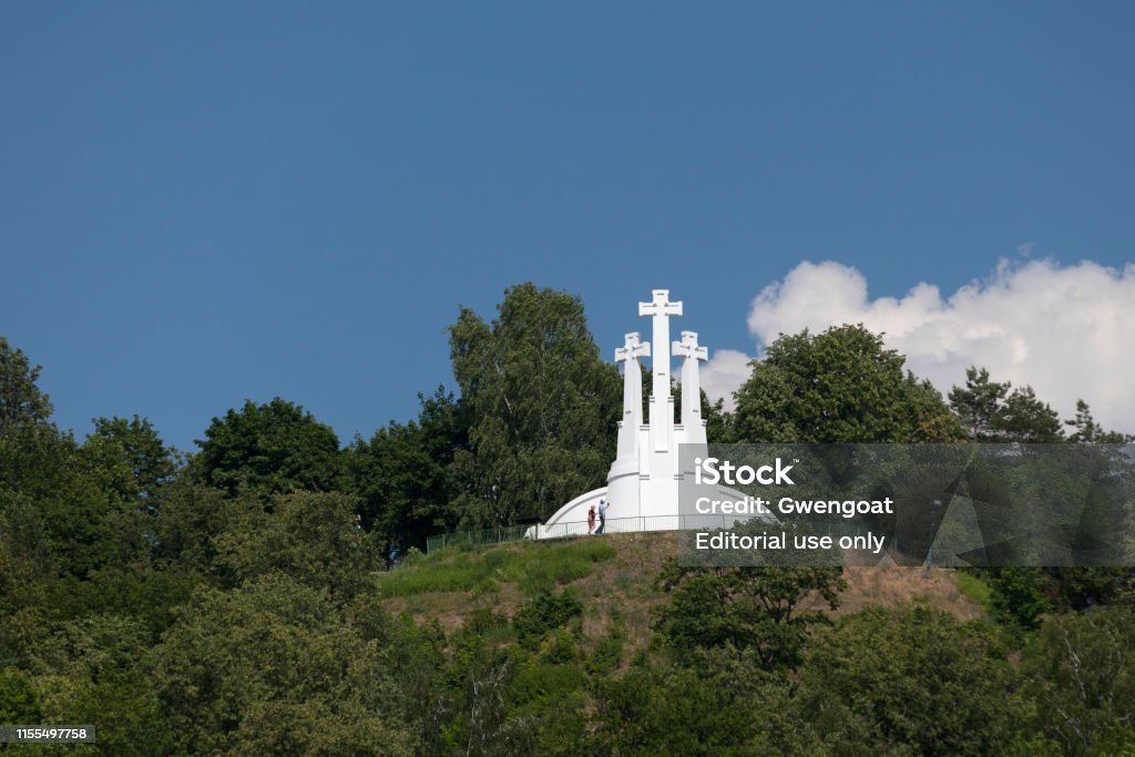 Three Crosses in Vilnius Vilnius, Lithuania - June 12 2019: Three Crosses is a prominent monument in the Lithuanian capital, on the Hill of Three Crosses, originally known as the Bald Hill (Lithuanian: Plikasis kalnas), in Kalnai Park. Architecture Stock Photo
