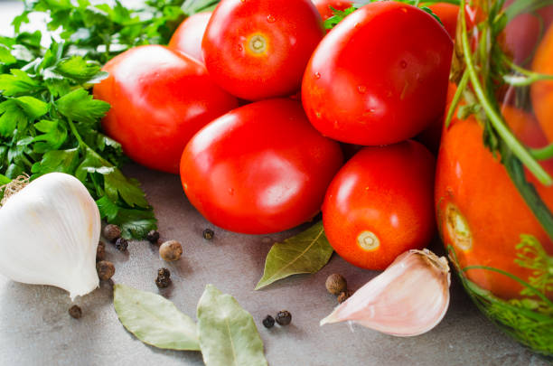 istock Preparation marinated conservation tomatoes with herbs, garlic, salt, and spice. 1155499299
