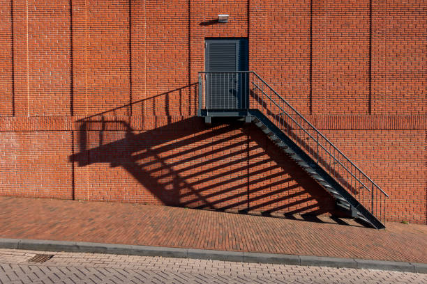 istock Fire escape staircase with bannister on red brick wall 1155503688