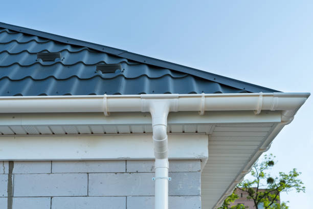 istock New metal tile roof with white rain gutter. SIP panel house construction. Unfinished building. 1155504921