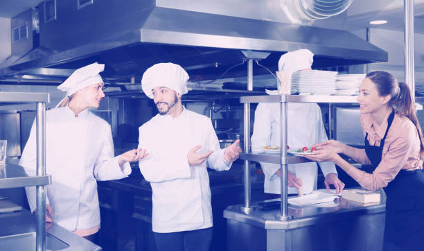 istock Staff of restaurant with nice chef in kitchen 1155506311