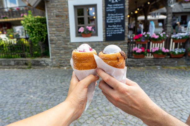 spooned ice cream filled chimney cake, traditional sweet dessert in middle europe kurtoskalacs trdelnik in tihany Hungary spooned ice cream filled chimney cake, traditional sweet dessert in middle europe kurtoskalacs trdelnik in tihany Hungary on street trdelník stock pictures, royalty-free photos & images
