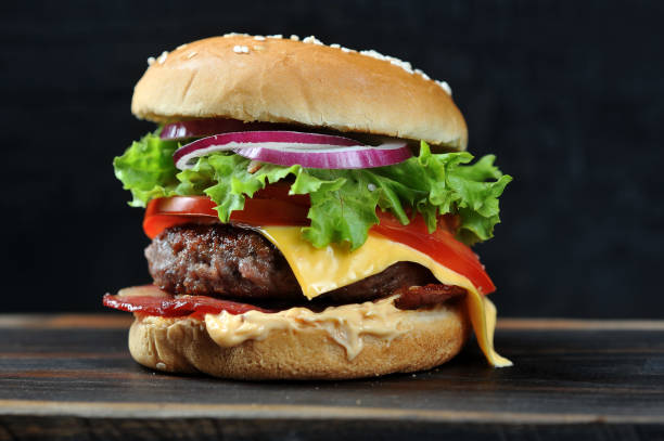 istock Cheeseburger with bacon on a dark background. Macro shooting. 1155511717