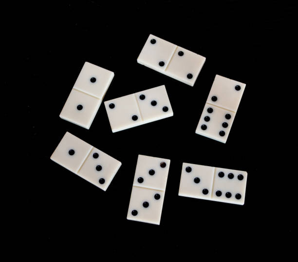 istock White Domino on the black table. 1155511770