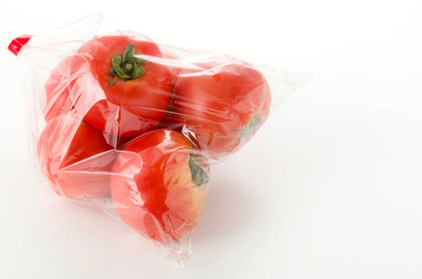 istock Ripe red Tomatoes in Plastic bag on white background 1155514233