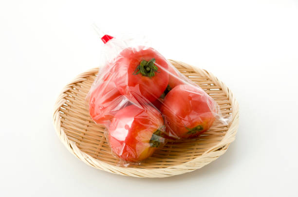 istock Ripe red Tomatoes in Plastic bag on bamboo colander 1155514278