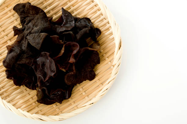 Jew's ear mushroom in a bamboo colander on white background Jew's ear mushroom in a bamboo colander on white background sunomono stock pictures, royalty-free photos & images