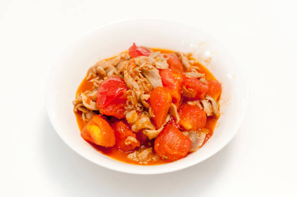 istock Chicken Tomato Stir Fry on white background 1155516210