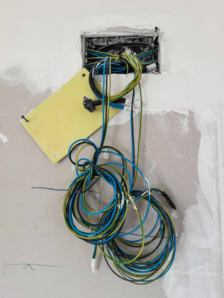 istock Light switch with no plate on the wall for refurbishment with cables hanging before installation 1155520015