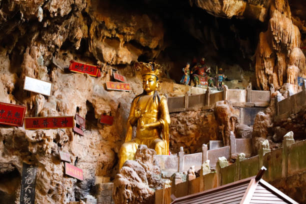 A statue of a god in Jianshui Swallow Cave in Yunnan, China stock photo