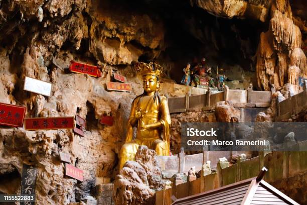 A Statue Of A God In Jianshui Swallow Cave In Yunnan China Stock Photo - Download Image Now
