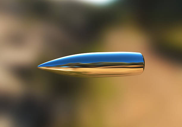 Silver bullet in flight Macro shot of silver bullet caught in flight. See also: Silver Bullet stock pictures, royalty-free photos & images