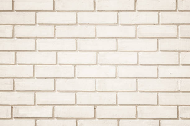 istock Cream colors and white brick wall art concrete or stone texture background. 1155525524