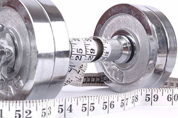 istock pair of weights with measuring tape on white background 115552664