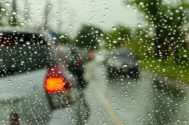 istock Blurred car images with drops of wate 1155531860