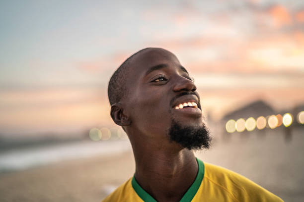 istock Black man smiling and looking at view in Rio de Janeiro 1155531880