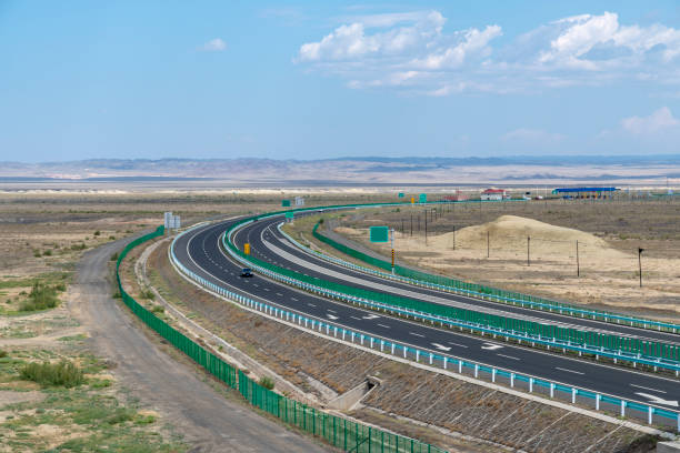 istock Highway perspective in blue sky and white clouds 1155532054