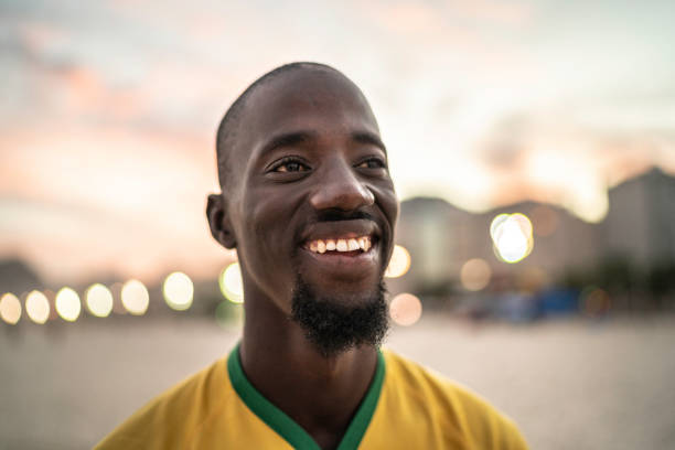 istock Black man smiling and looking at view in Rio de Janeiro 1155532136