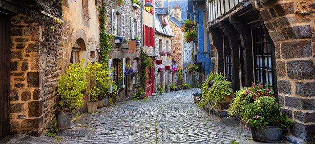 Dinan, traditional colorful houses on a cobbled street in medieval town center, Brittany, France