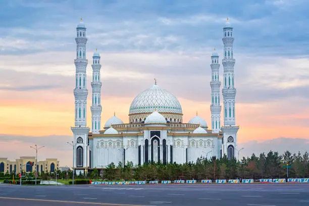 Nur-Sultan (Astana), Kasakhstan, beautiful white Hazrat Sultan mosque, the largest mosque in Central Asia, in dramatical sunset light