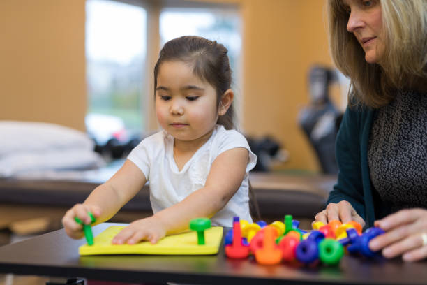 istock Occupational therapist works with a young ethnic girl 1155533391