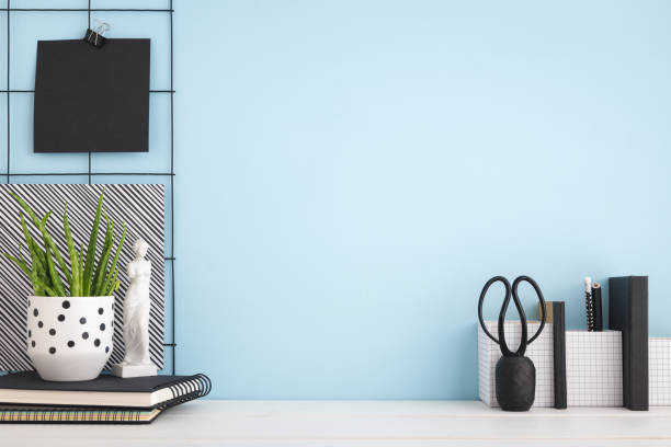istock Office creative desk with supplies, and blue wall. Mock up 1155533588