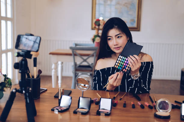 istock beauty blogger live broadcasting cosmetic makeup tutorial on social media. 1155534181