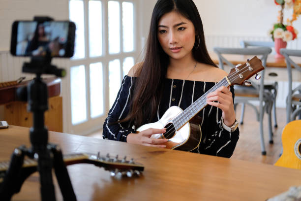 istock blogger live broadcasting music instrument tutorial on social media. vlogger recording online vlog video. 1155534182