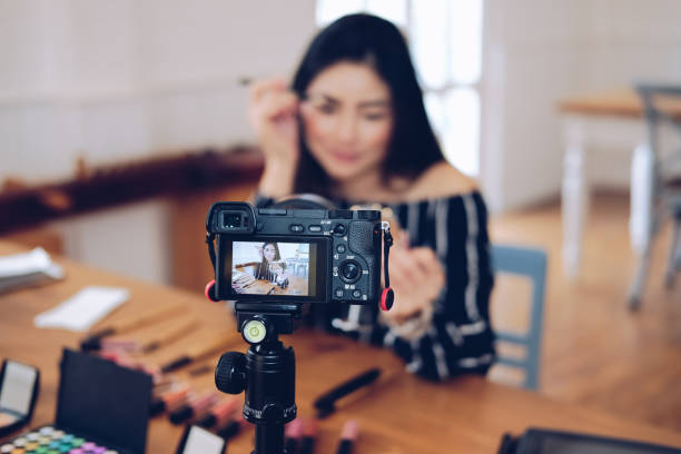 istock beauty blogger live broadcasting cosmetic makeup tutorial on social media. 1155534188