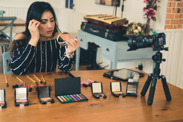 istock beauty blogger live broadcasting cosmetic makeup tutorial on social media. 1155534194