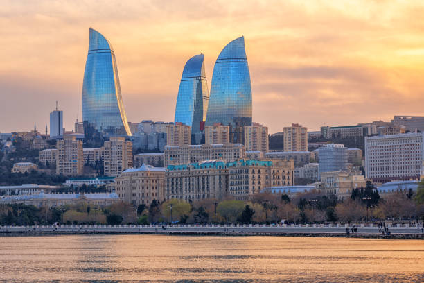 Baku, Azerbaijan, view of the city and Flower Tower skyscrapers Baku, Azerbaijan, with Flower Tower skyscrapers dominating the city on dramatical sunset baku photos stock pictures, royalty-free photos & images