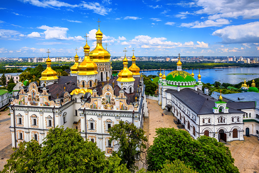 Kiev, Ukraine, golden domes of christian orthodox Dormition cathedral in Kyiv Monastery of the Caves or Kiev Pechersk Lavra on Dniepr river
