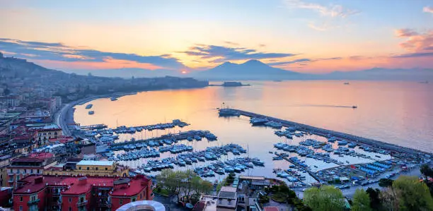 Panoramic view of Naples city, Italy, with Gulf of Napoli and Mount Vesuvius volcano, at sunrise