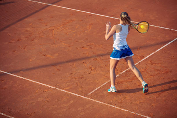 istock Young woman playing tennis on clay. Forehand. 1155535680